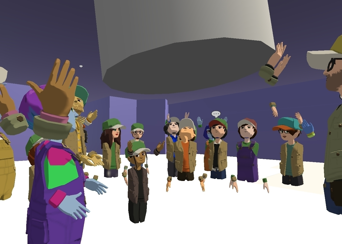 An audience of avatars, all in baseball caps, stand in a circle in the Collider Altspace world, with instructions from the Collider team on how to navigate the experience. Some audience members are learning to use emojis, which are floating above their avatar heads.